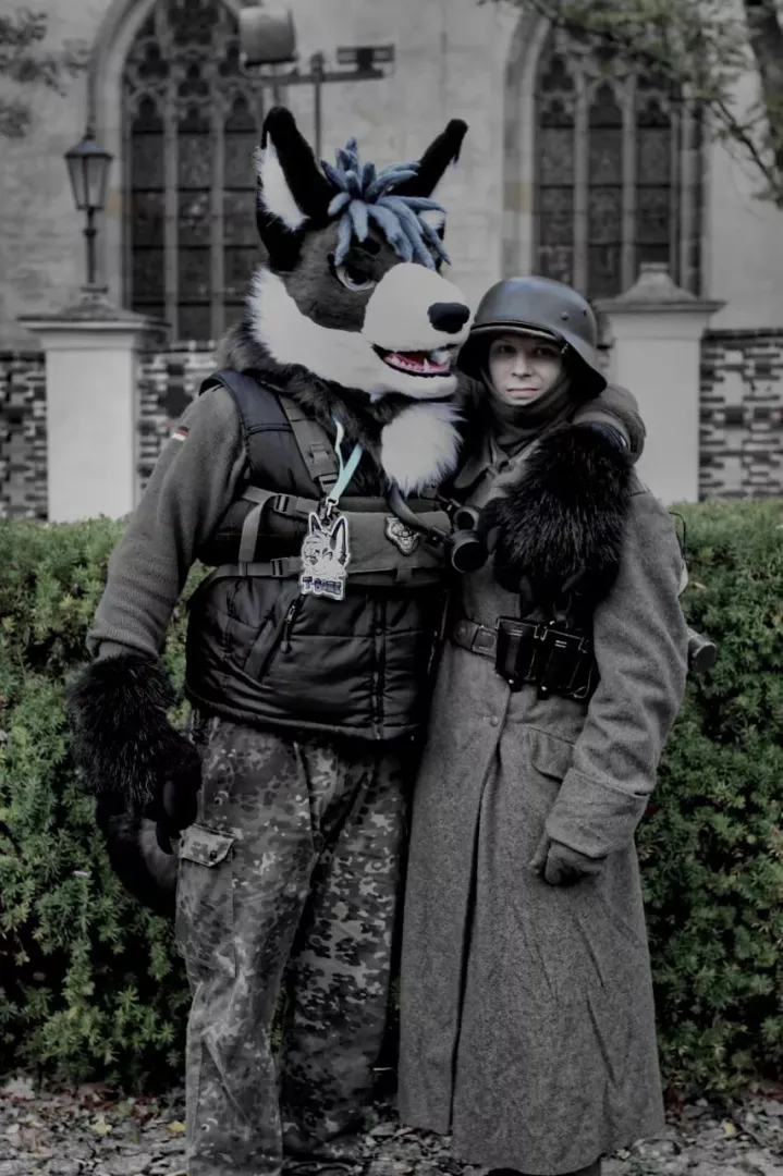 A German soldier with his fur compation on patrol.