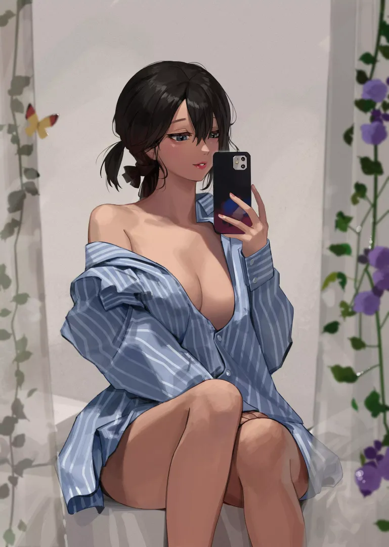 A mirror selfie in oversized shirt