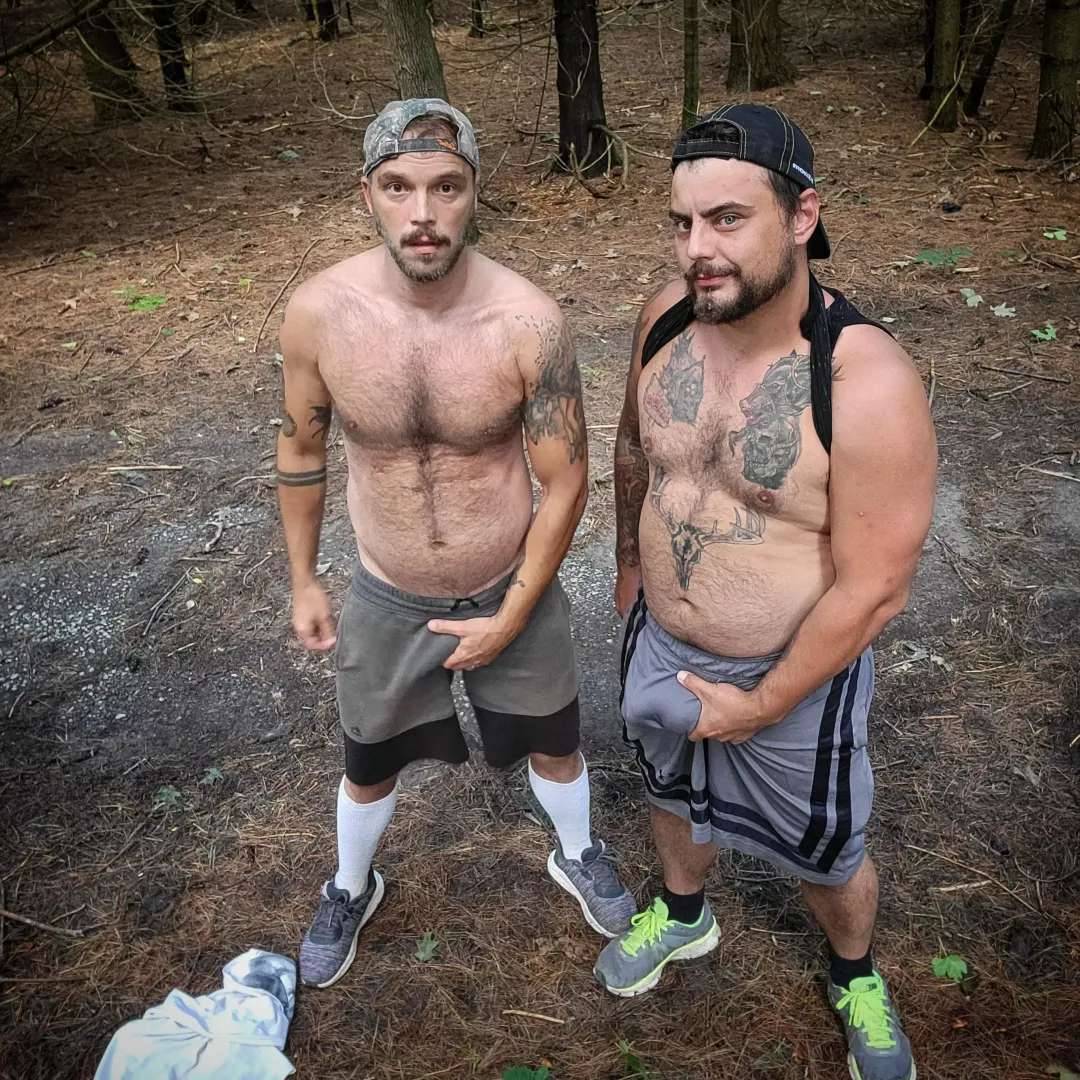 An otter and his bear in the woods.