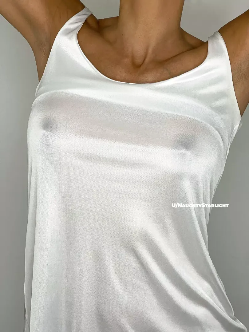 Back to basics: braless in a white tank top