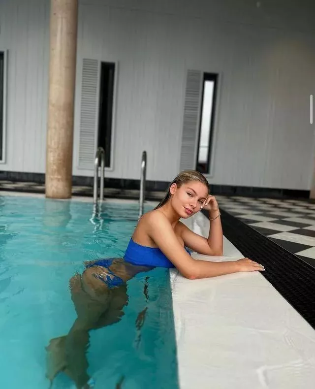 Blonde wearing blue in the pool