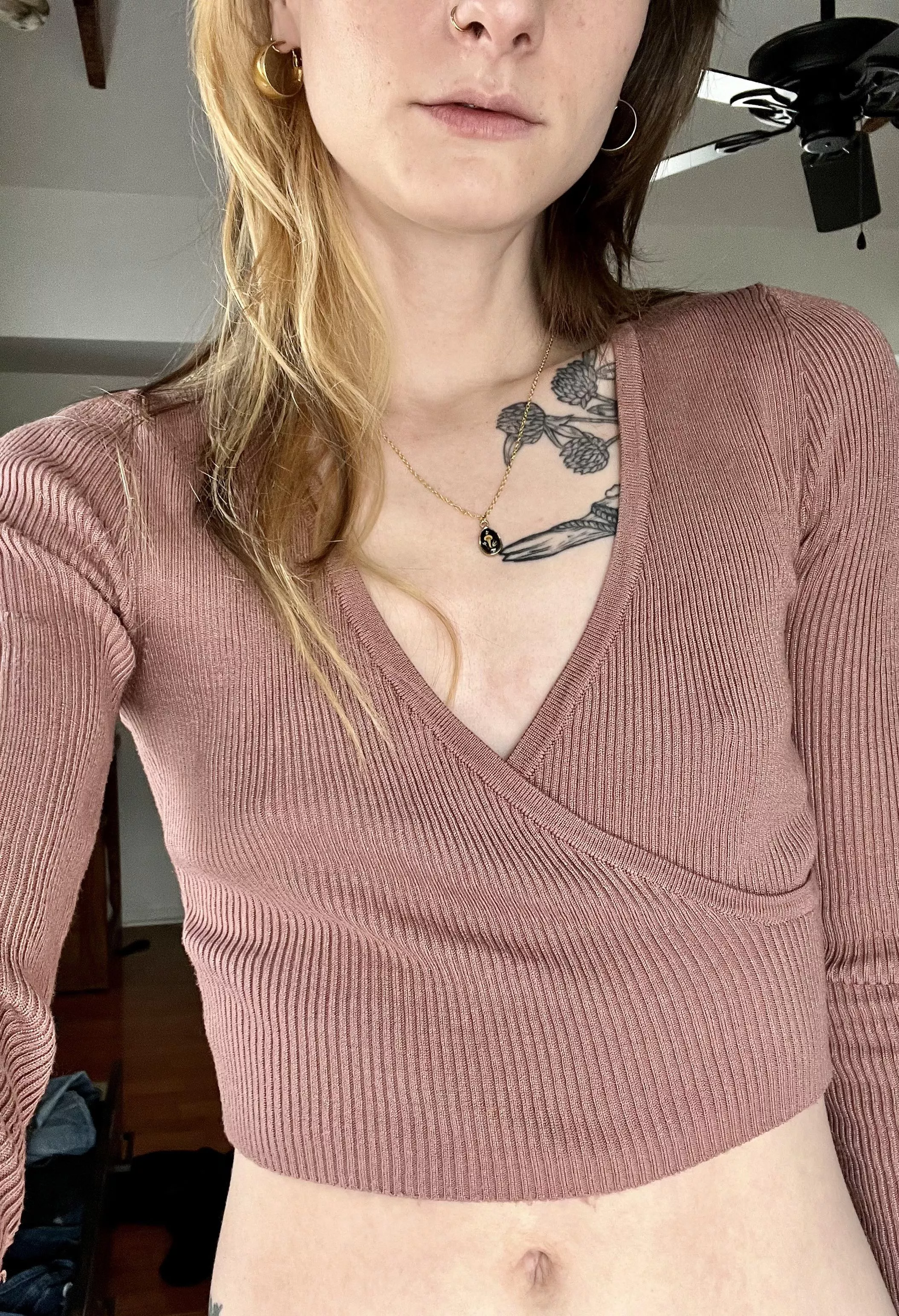 In a cropped sweater