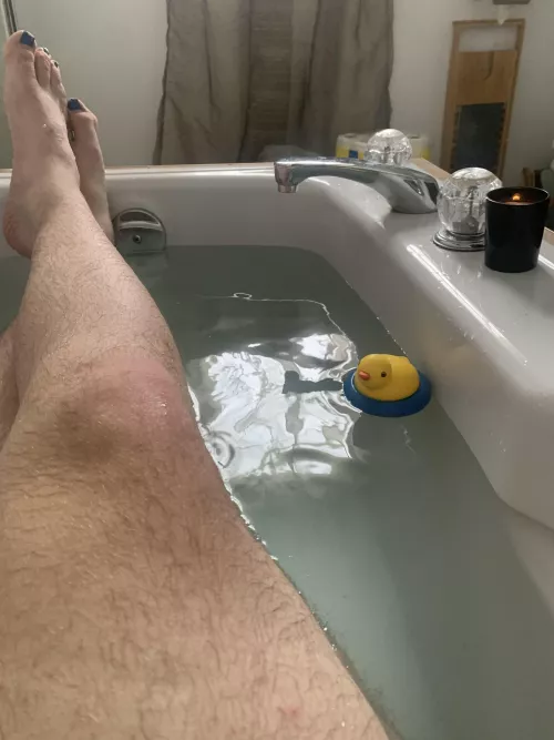 Just a man taking a bath with his duck.
