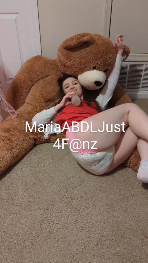 Living my best life with my bottle, big teddy bear, and lots of cute red dresses!