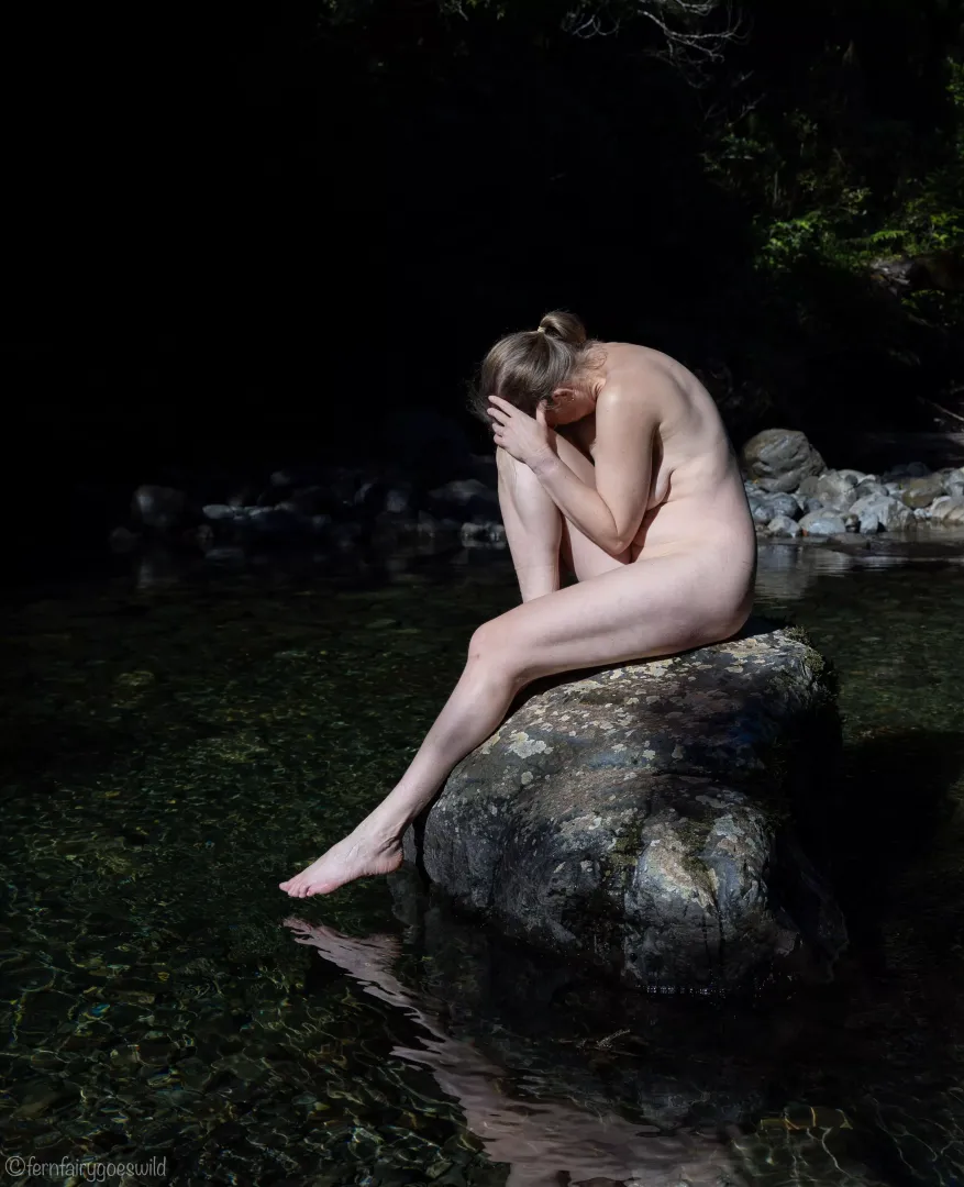 Self portrait on a rock in the river