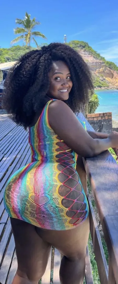 Sexy black babe pushing that dress to the limits