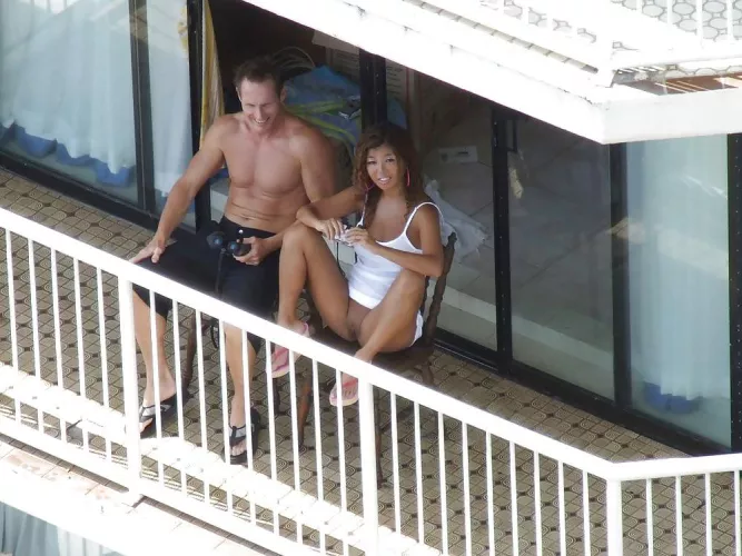 She flashing her neighbours on the balcony