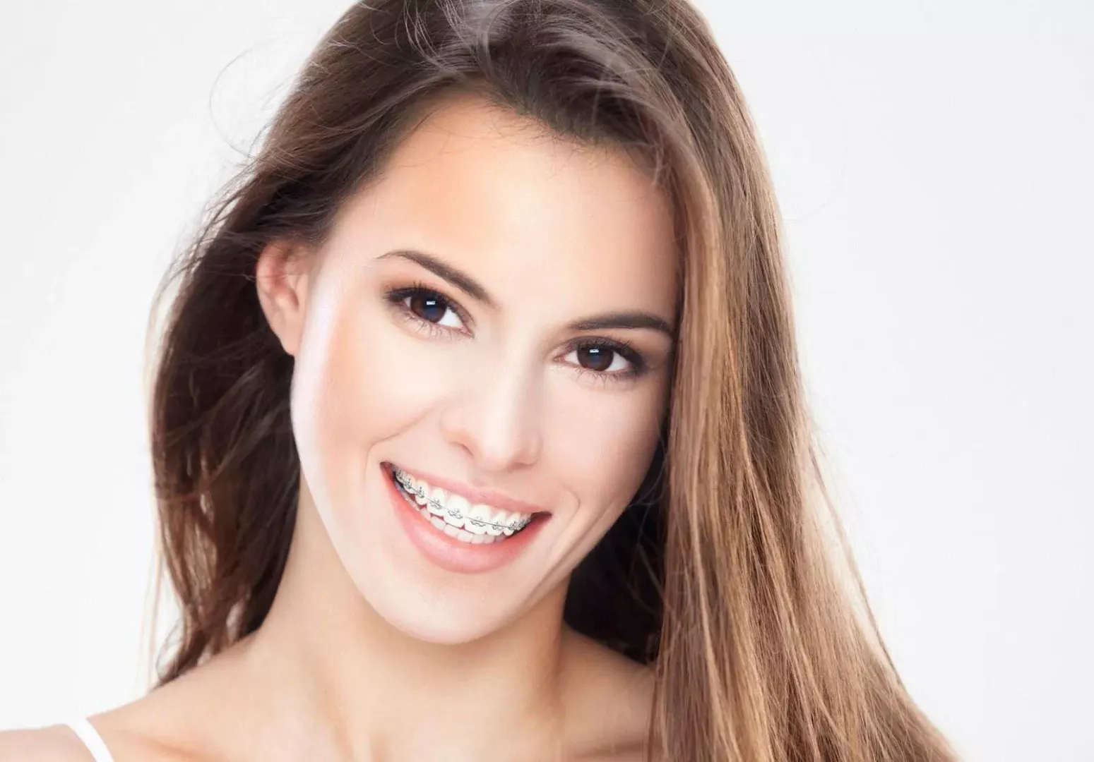 Smiling brunette in braces