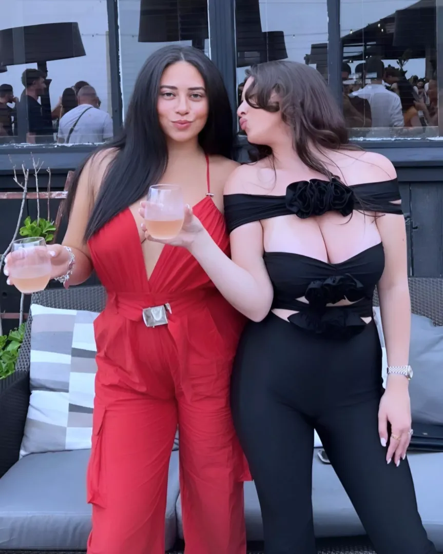 Spilling out her shirt on the right