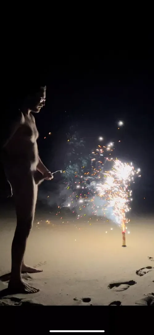 Spraying in front of New Years fireworks