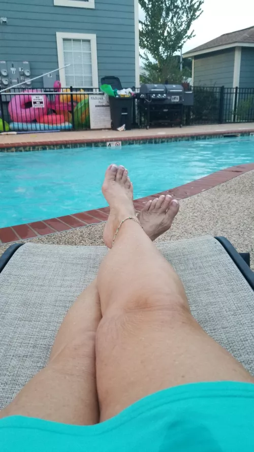 The wife by the pool. showing off her 62 year old legs.