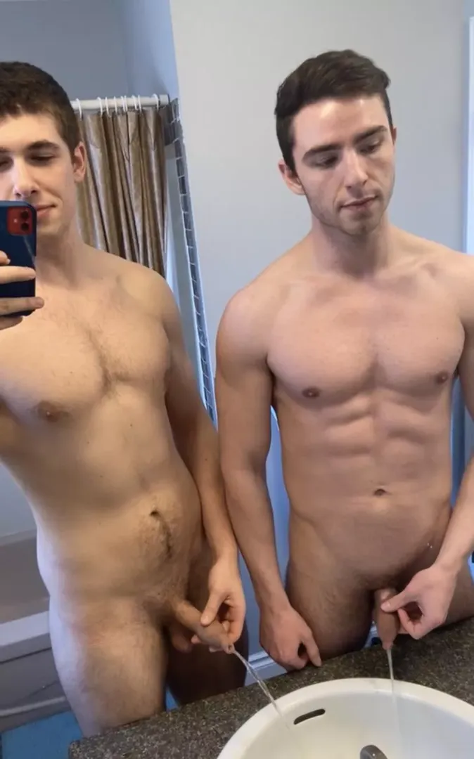 Two guys pissing