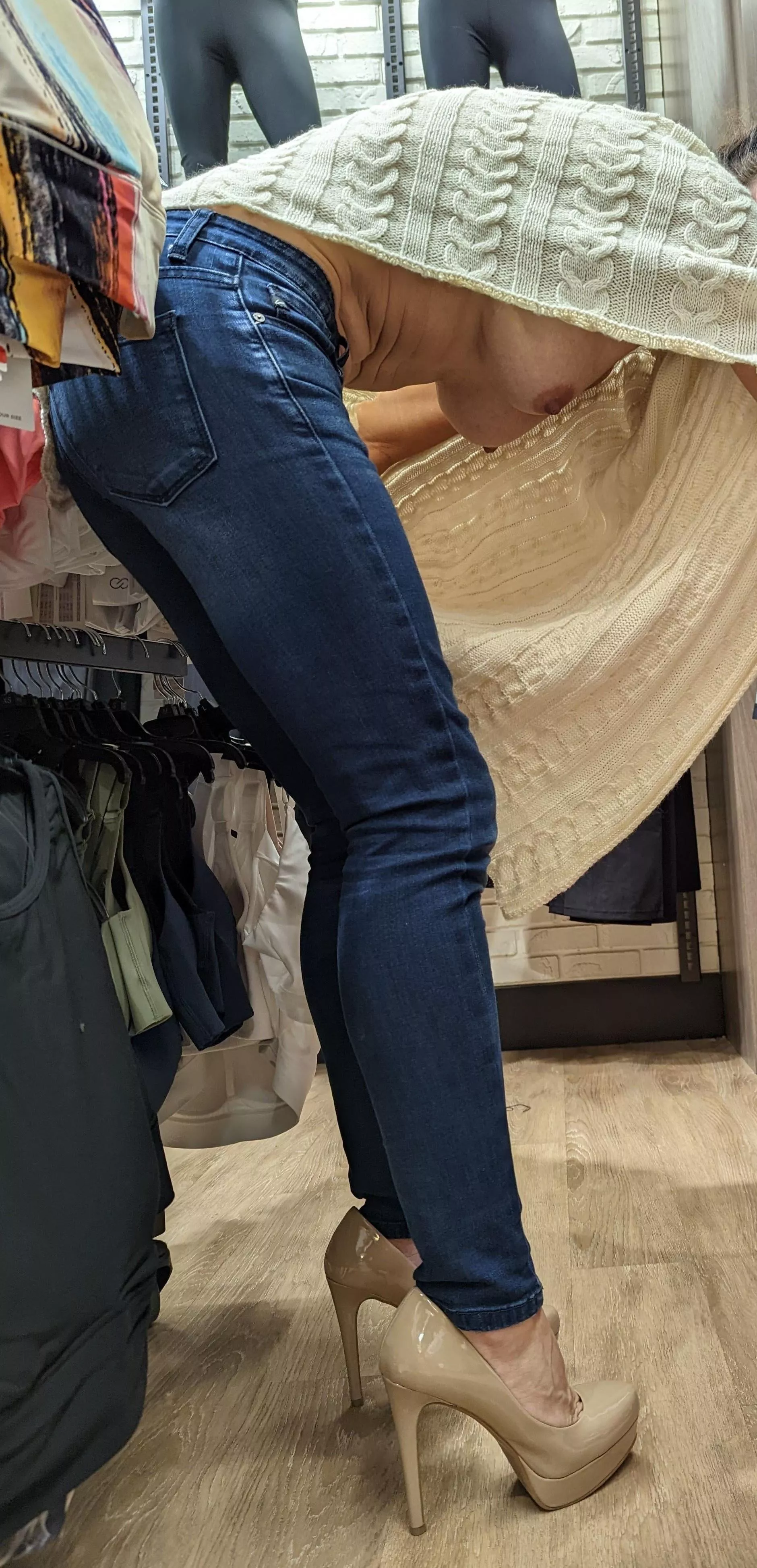 Wi(f)e shopping with nothing under her poncho sweater